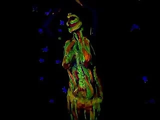 Glowing paint at night on a nude body.